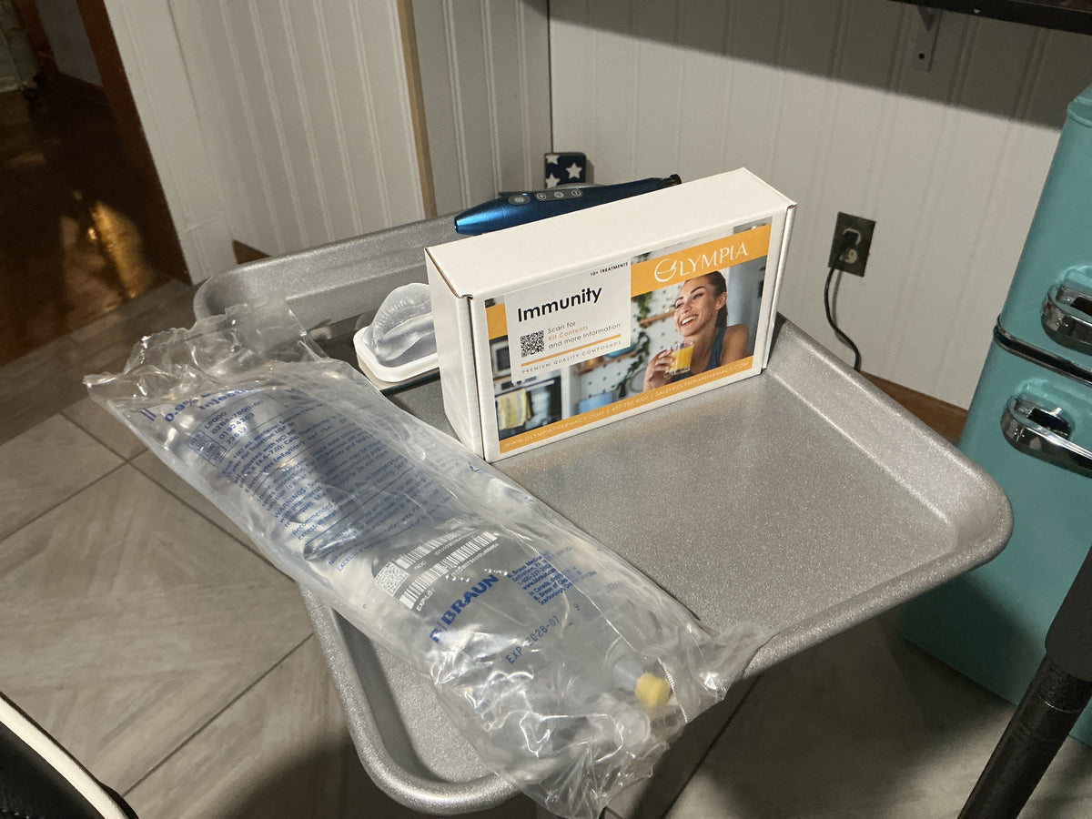 Olympia Immunity IV kit and saline bag prepared on a treatment tray